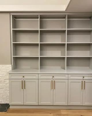 Custom-built corner storage with shelving and cabinetry, showcasing tailored design solutions for pantries and small closet spaces.